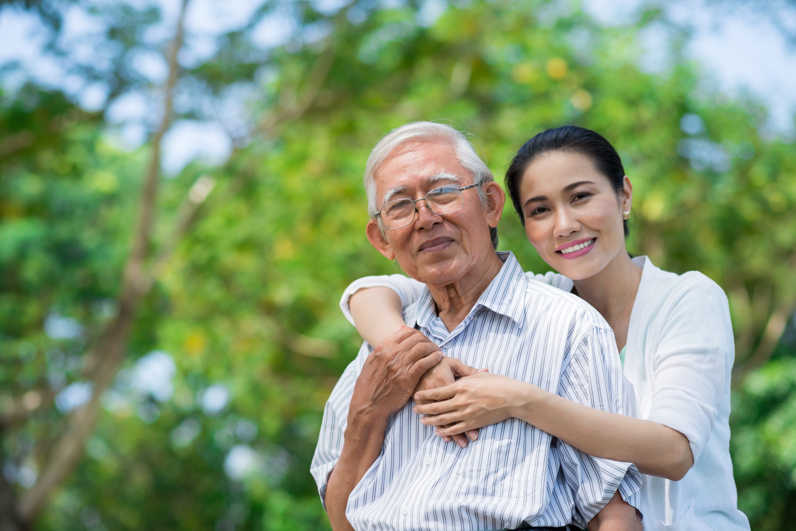 Portrait,Of,Smiling,Vietnamese,Woman,Hugging,Her,Father